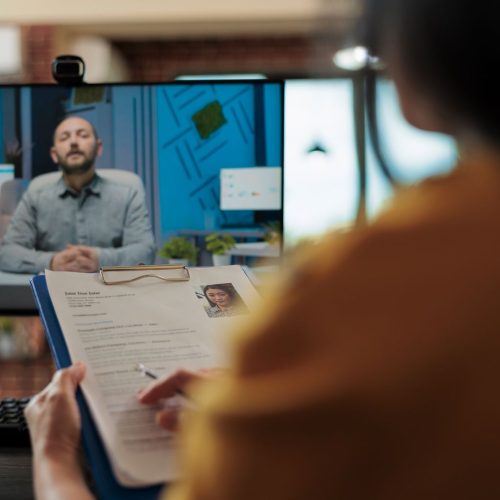 Businesswoman analyzing candidate cv discussing hiring cv with remote man during online videocall meeting. Businesspeople working at company strategy discussing partnership in startup office